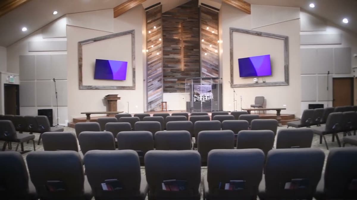 Renovated sanctuary at Redemption Hills Church - seating, stage, and reclaimed wood feature wall