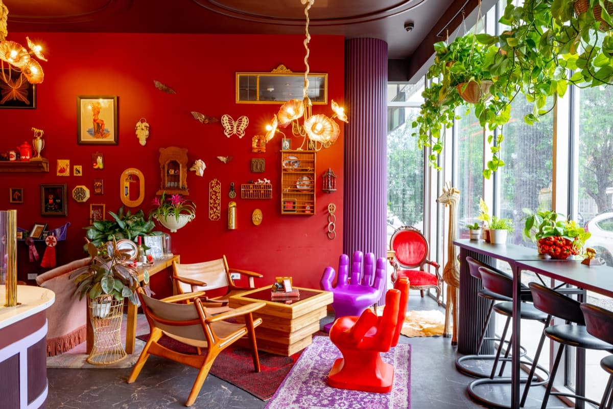 Lounge seating corner with vintage furniture and gallery wall at Velvet Lasso