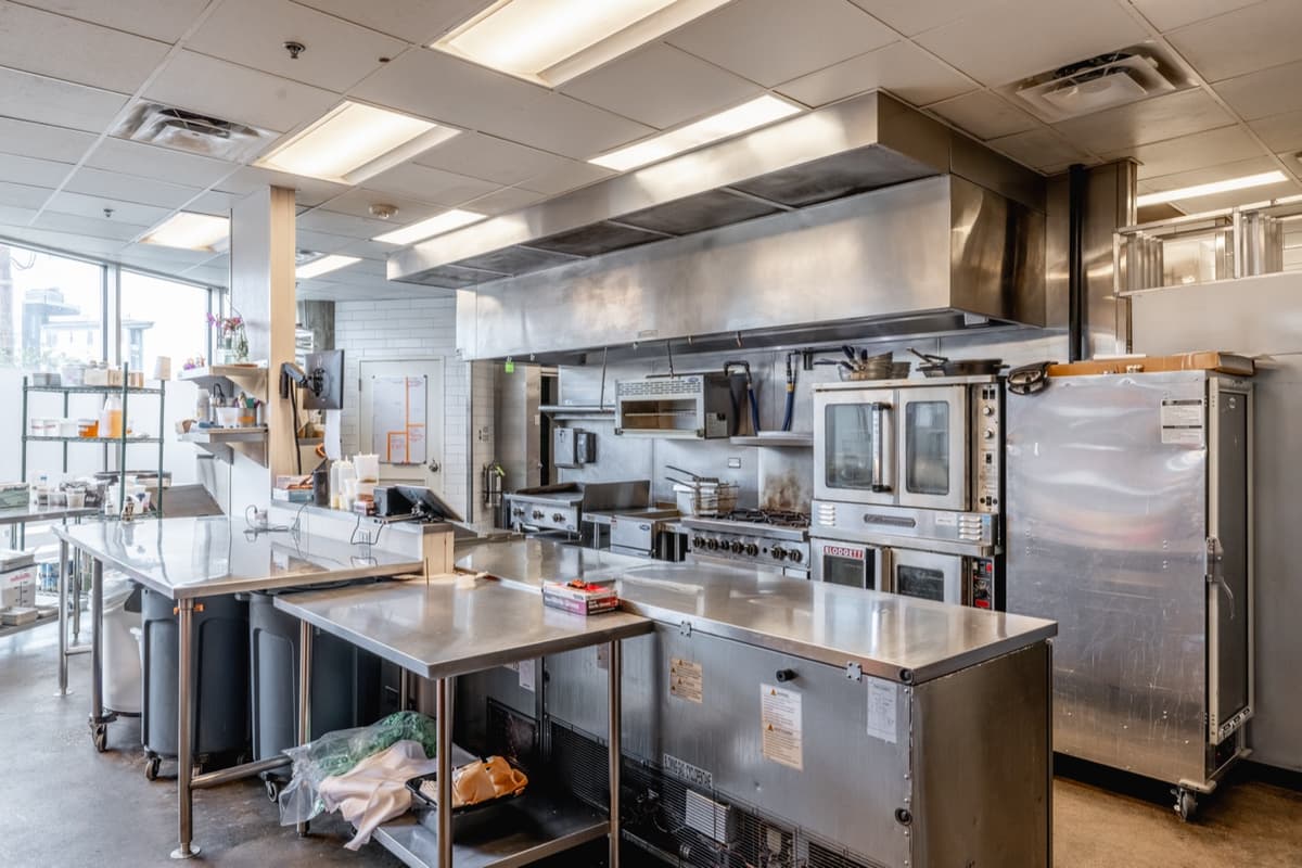 Commercial kitchen with stainless equipment and hood at Velvet Lasso
