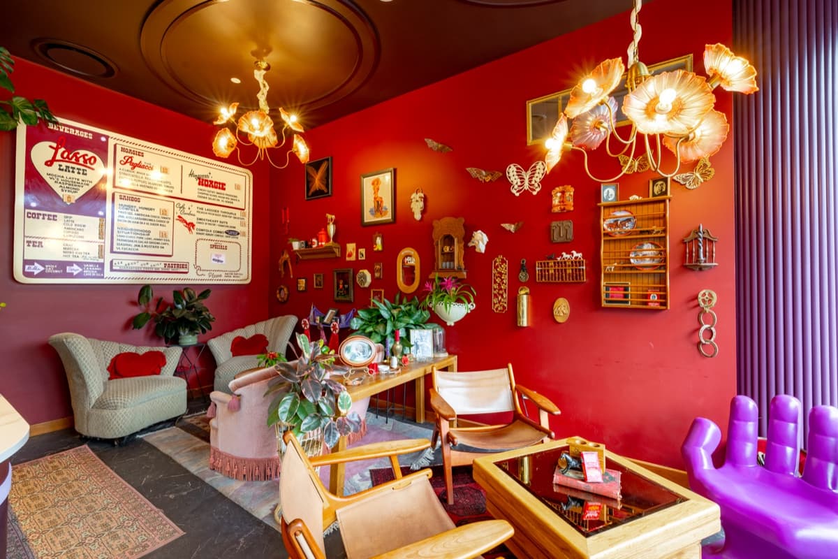 Lounge seating beneath the menu board wall at Velvet Lasso in Denver