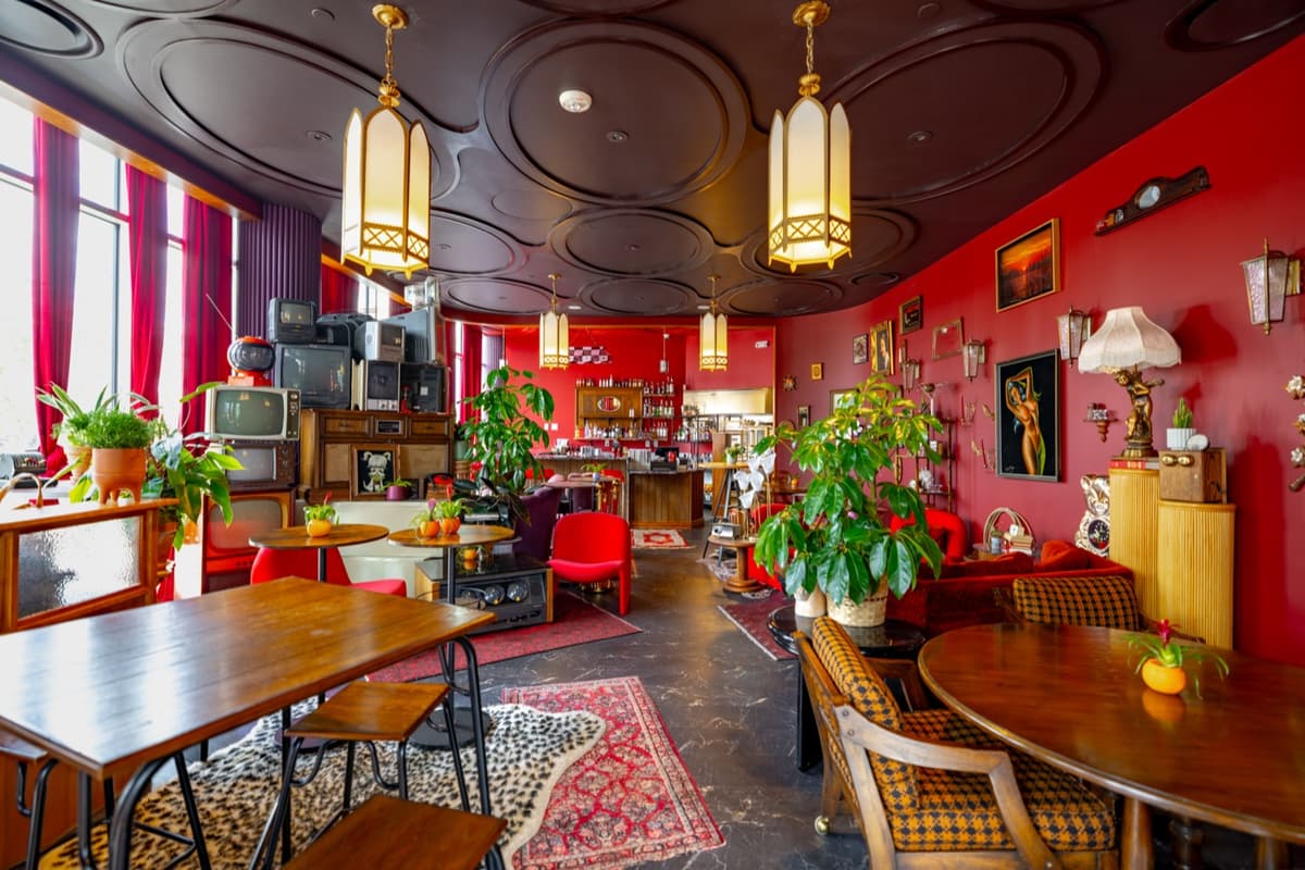 Dining area with communal table, patterned rugs, and curated vintage decor at Velvet Lasso
